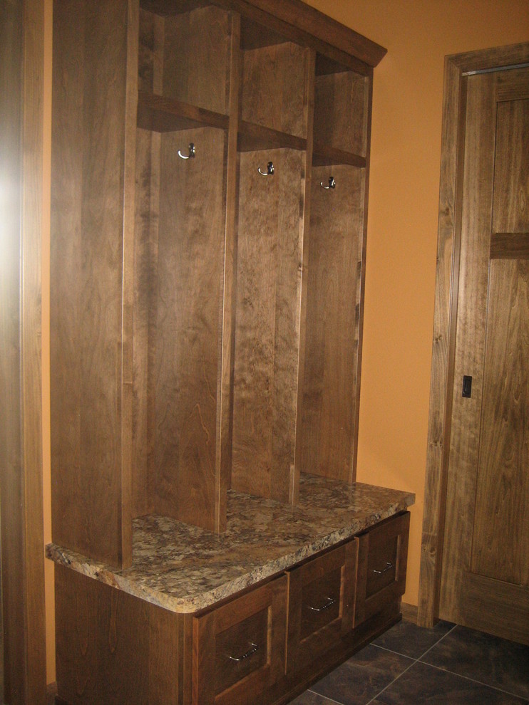 Example of a mid-sized mountain style mudroom design with orange walls