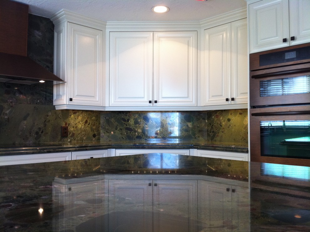 Inspiration for a large transitional u-shaped terrazzo floor and black floor open concept kitchen remodel in Miami with a single-bowl sink, raised-panel cabinets, white cabinets, granite countertops, multicolored backsplash, stone tile backsplash, stainless steel appliances and an island