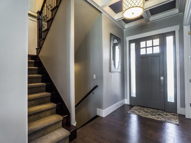 Inspiration for a small transitional front door in Salt Lake City with grey walls, medium hardwood floors, a single front door and a gray front door.