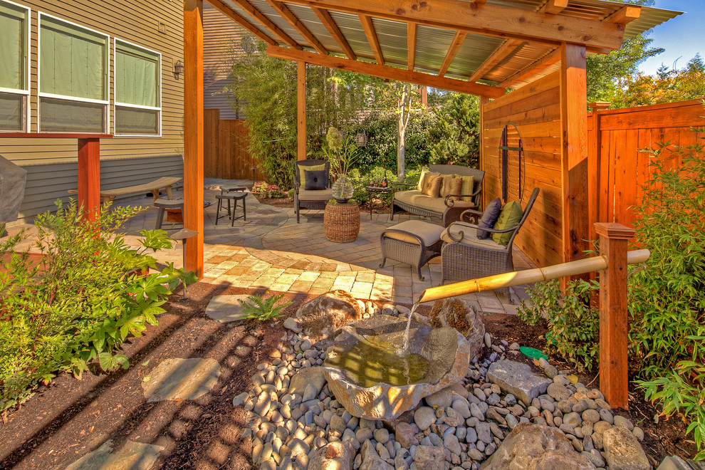 This is an example of a traditional patio in Portland with a water feature.