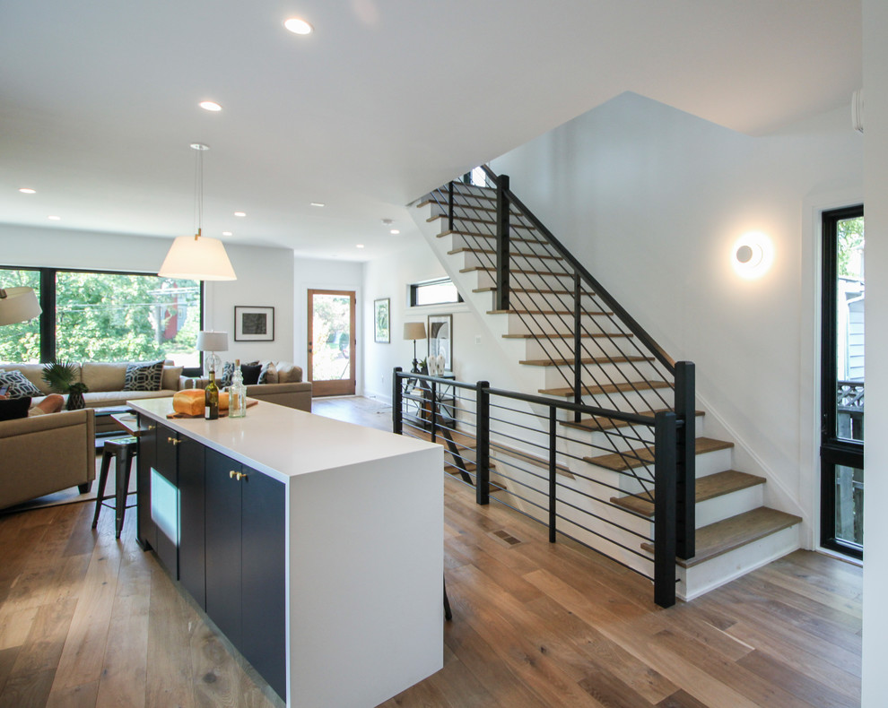 This is an example of a large modern wood straight staircase in DC Metro with wood risers and mixed railing.