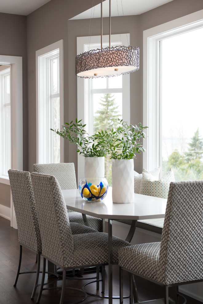 Inspiration for a transitional dining room in Minneapolis with grey walls and dark hardwood floors.