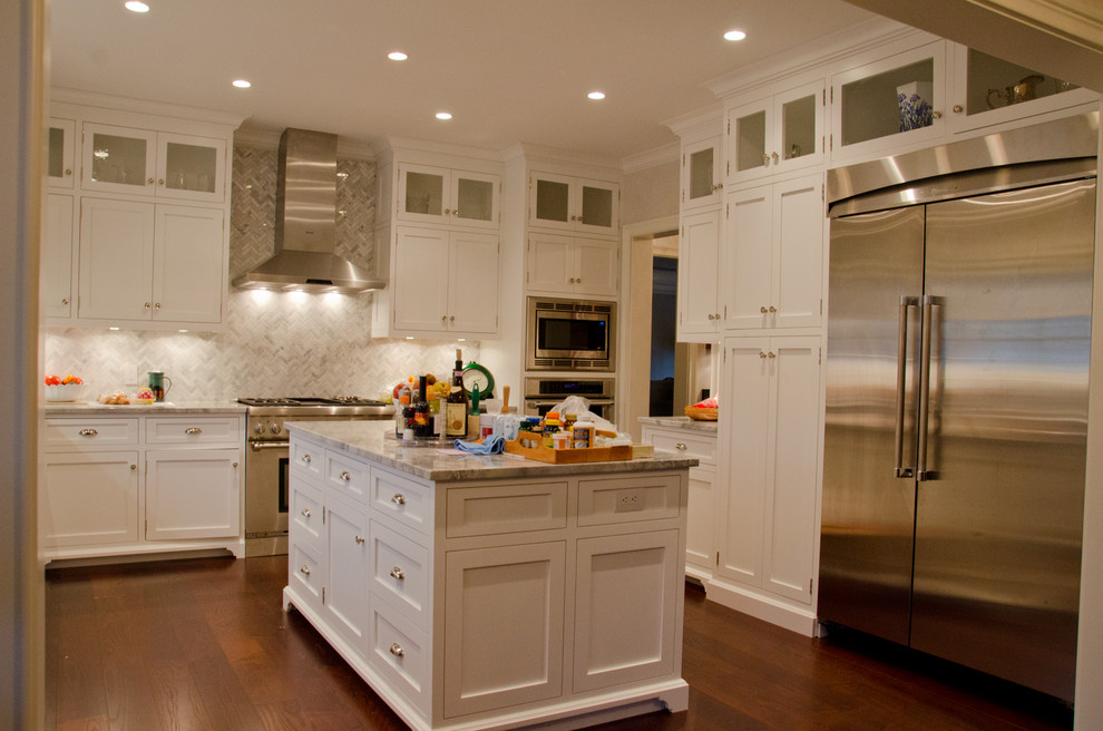 Inspiration for a mid-sized transitional u-shaped kitchen in New York with shaker cabinets, white cabinets, with island, marble benchtops, grey splashback, marble splashback, stainless steel appliances, medium hardwood floors, brown floor and grey benchtop.