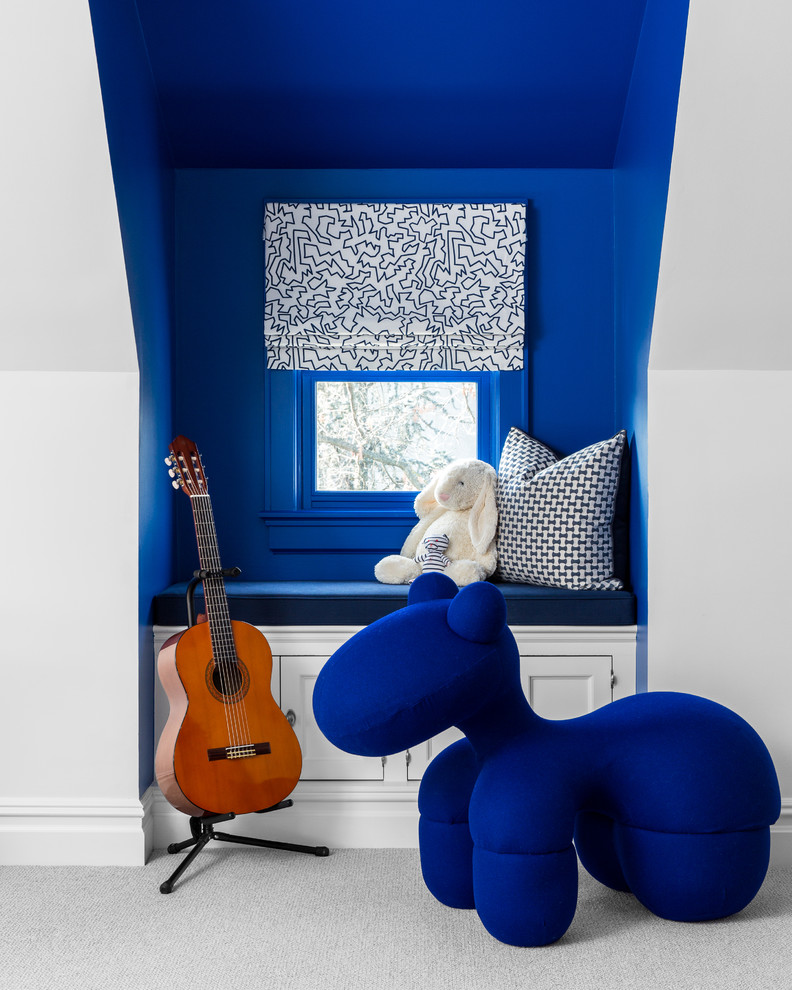 Photo of a transitional kids' room in New York with blue walls, carpet and grey floor.