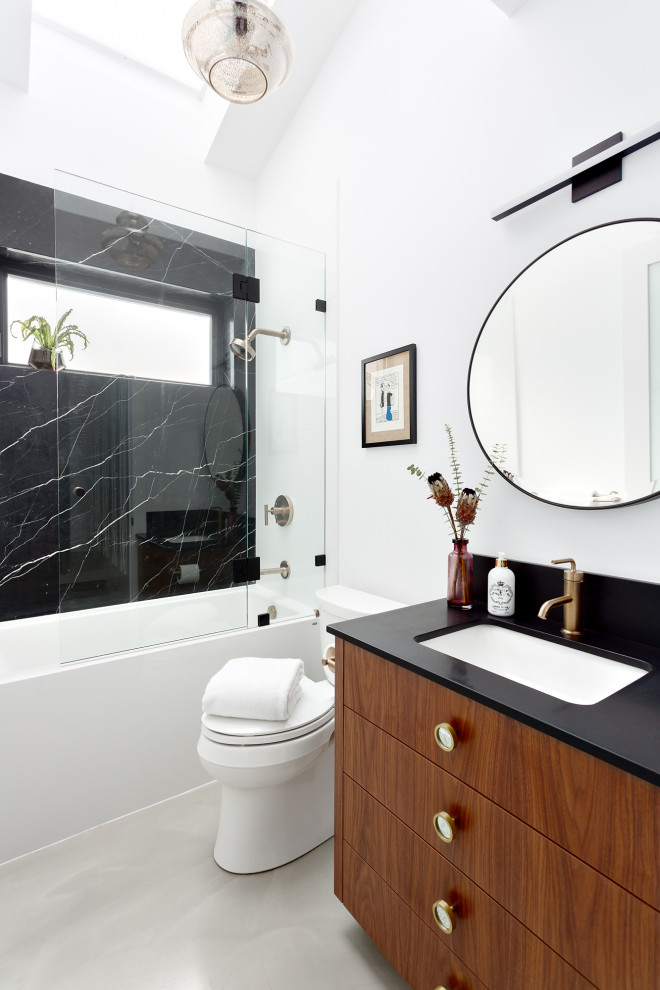 Inspiration for a contemporary 3/4 bathroom in Vancouver with a drop-in tub, a one-piece toilet, white walls, a drop-in sink, a hinged shower door, black benchtops and a single vanity.
