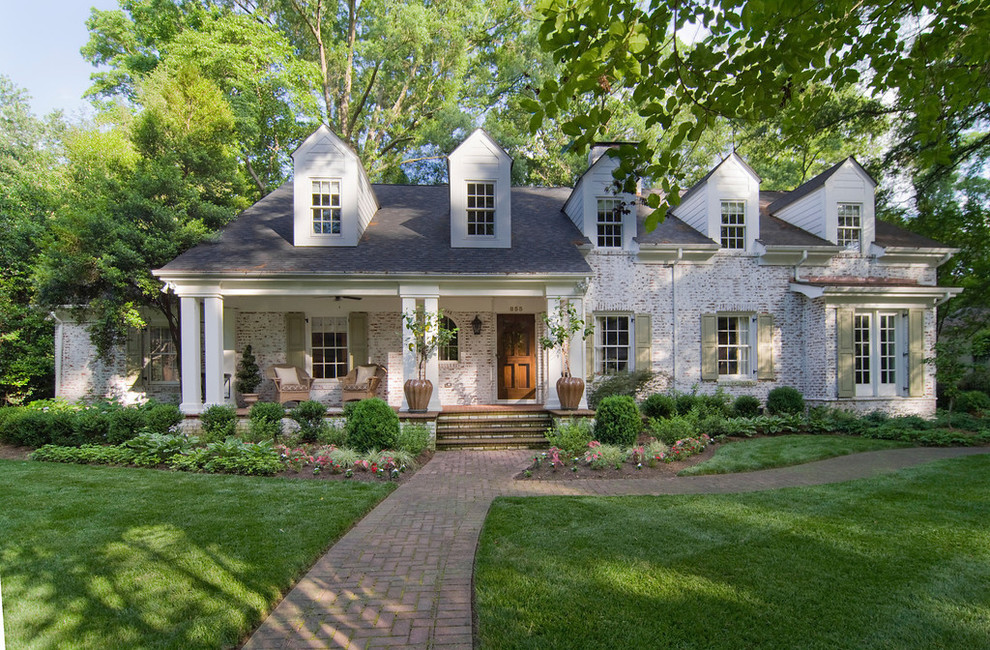 Photo of a mid-sized traditional two-storey brick white exterior in Charlotte.