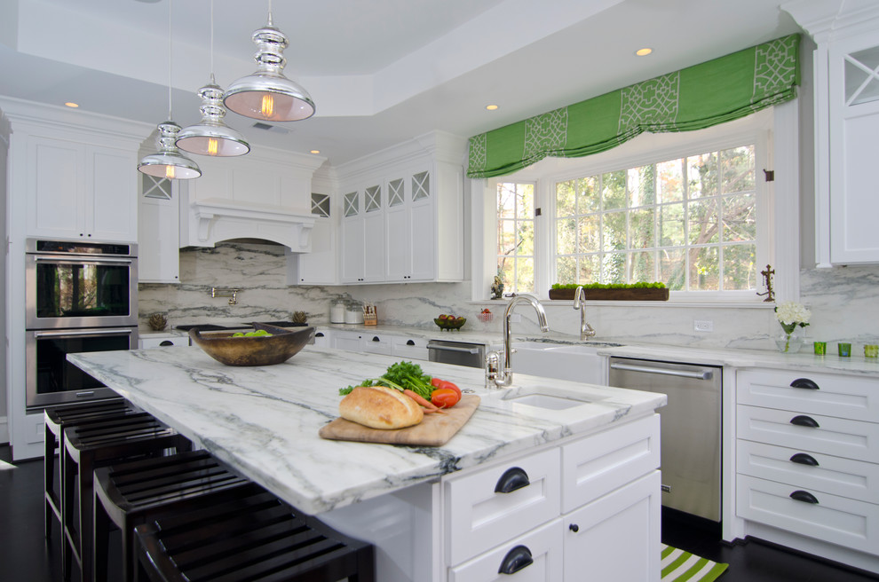 Inspiration for a transitional l-shaped dark wood floor eat-in kitchen remodel in DC Metro with white cabinets, marble countertops, white backsplash, stainless steel appliances, white walls, an island and a farmhouse sink