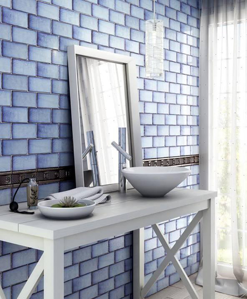 This is an example of a mid-sized country powder room in Sydney with blue tile, ceramic tile, blue walls, light hardwood floors, a vessel sink, wood benchtops, white floor and white benchtops.