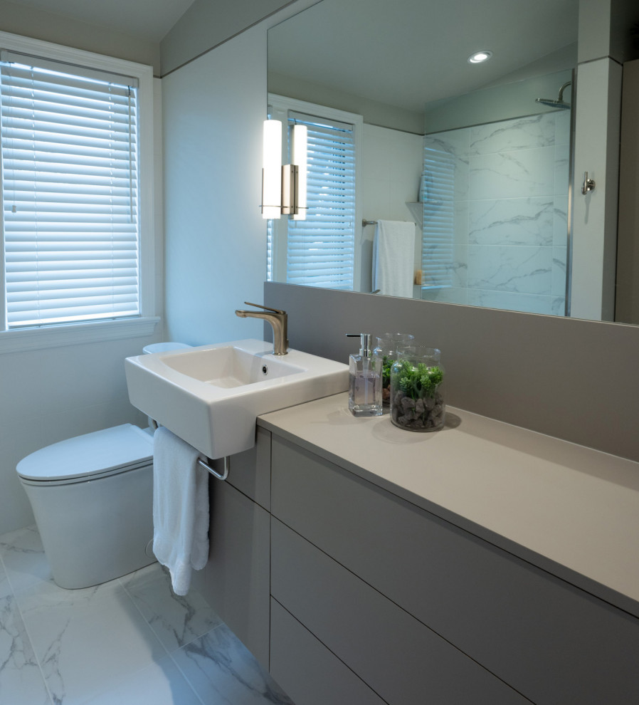 Photo of a medium sized modern bathroom in Ottawa with flat-panel cabinets, grey cabinets, an alcove shower, a one-piece toilet, white tiles, porcelain tiles, white walls, porcelain flooring, laminate worktops, white floors, grey worktops, a single sink and a floating vanity unit.