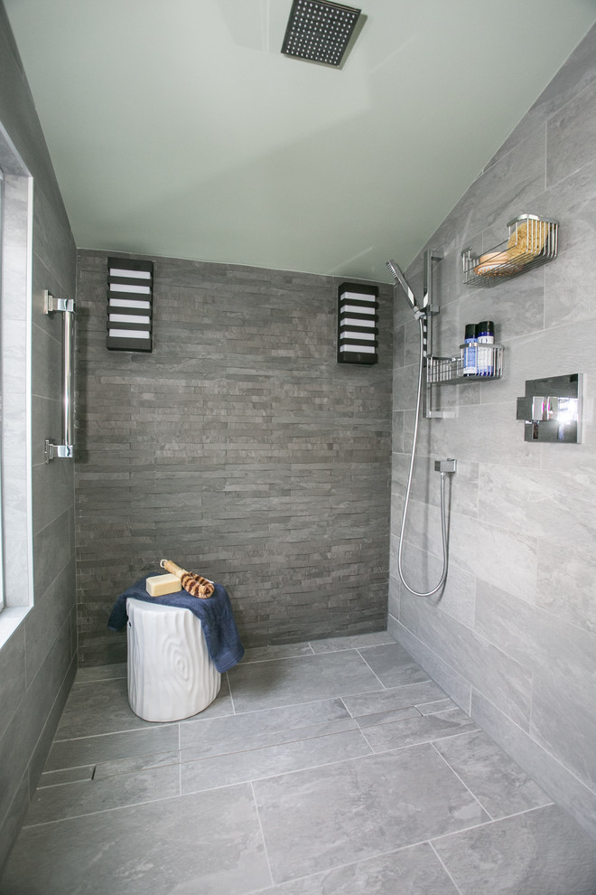 Inspiration for a mid-sized contemporary master bathroom in Philadelphia with furniture-like cabinets, brown cabinets, a curbless shower, a wall-mount toilet, gray tile, ceramic tile, green walls, ceramic floors, an undermount sink, granite benchtops, grey floor, an open shower and beige benchtops.