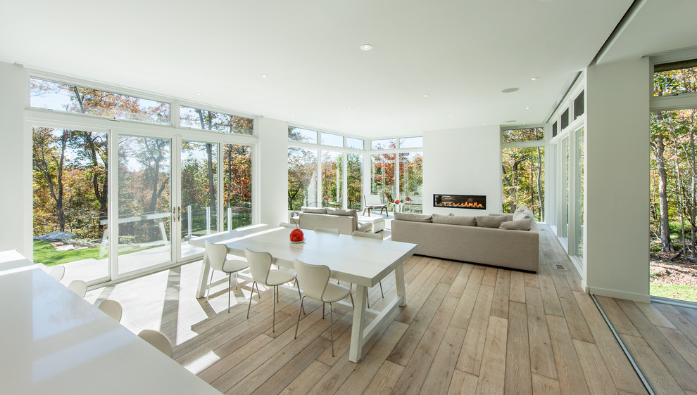 This is an example of a contemporary open plan dining in Other with white walls and medium hardwood floors.