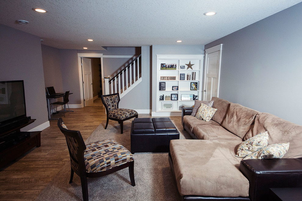 This is an example of a large transitional open concept family room in Edmonton with grey walls, linoleum floors and a freestanding tv.
