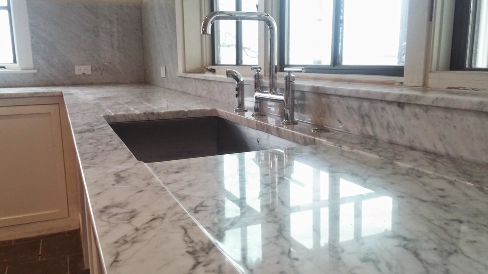 Inspiration for a mid-sized transitional porcelain tile open concept kitchen remodel in Austin with an undermount sink, shaker cabinets, white cabinets, marble countertops, gray backsplash, marble backsplash and stainless steel appliances
