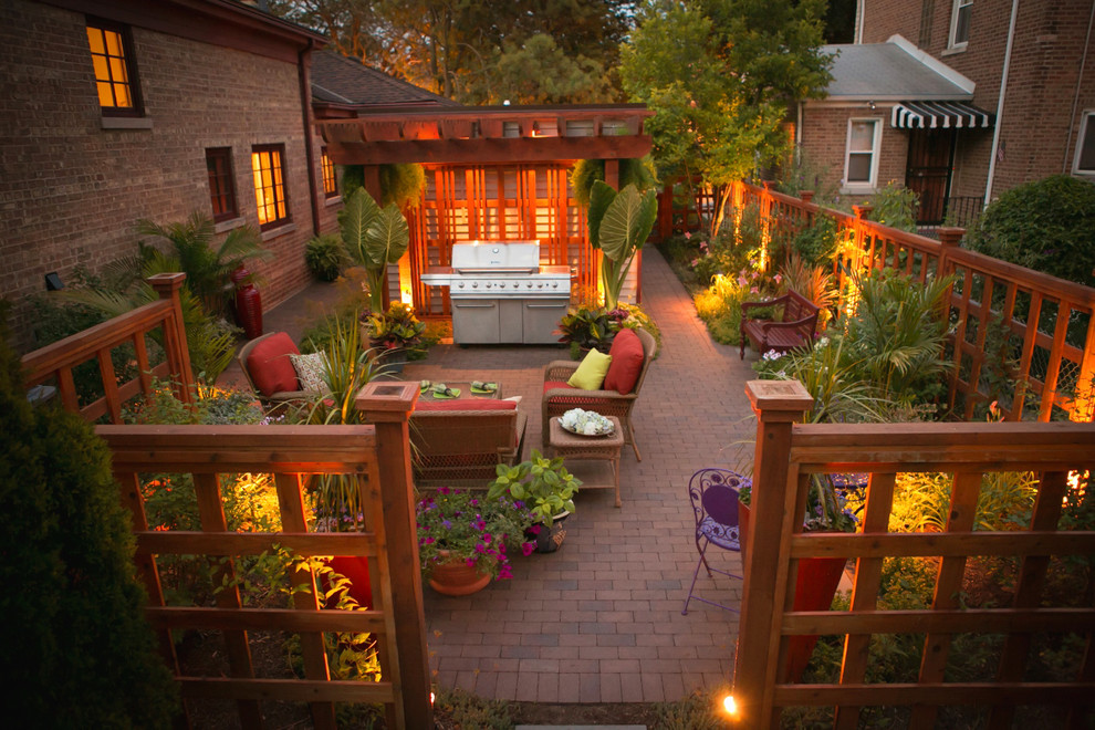 Inspiration for a small eclectic backyard full sun garden for summer in Chicago with a container garden and brick pavers.