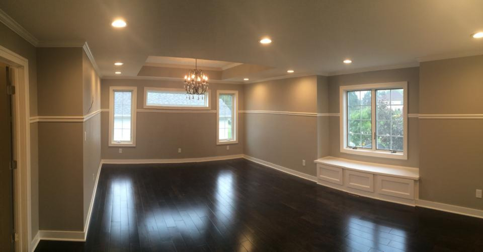 This is an example of a large transitional master bedroom in Other with grey walls, dark hardwood floors and no fireplace.