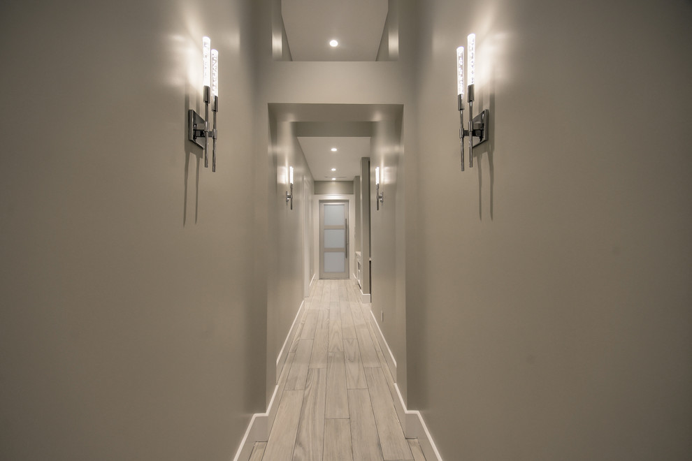 Large contemporary hallway in Houston with grey walls and porcelain floors.