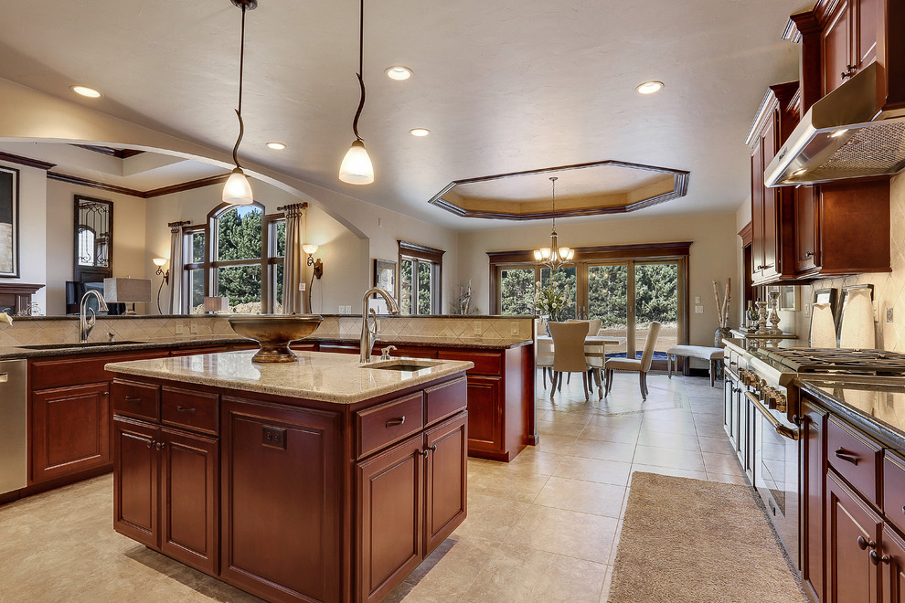 This is an example of a large traditional u-shaped eat-in kitchen in Other with raised-panel cabinets, dark wood cabinets, beige splashback, stainless steel appliances, ceramic floors and with island.