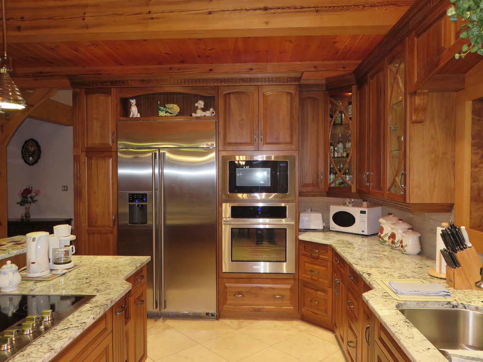 Example of a large transitional l-shaped ceramic tile open concept kitchen design with raised-panel cabinets, medium tone wood cabinets, granite countertops, stainless steel appliances, an island, a double-bowl sink, white backsplash and subway tile backsplash