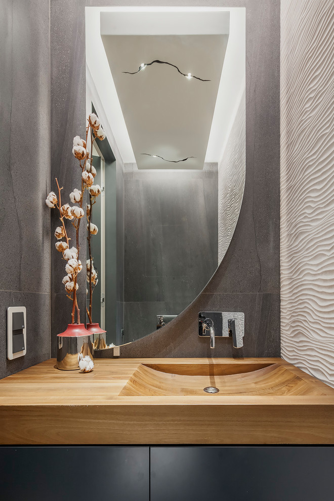 Small contemporary powder room in Other with flat-panel cabinets, grey cabinets, white tile, gray tile, ceramic tile, wood benchtops, an integrated sink and brown benchtops.