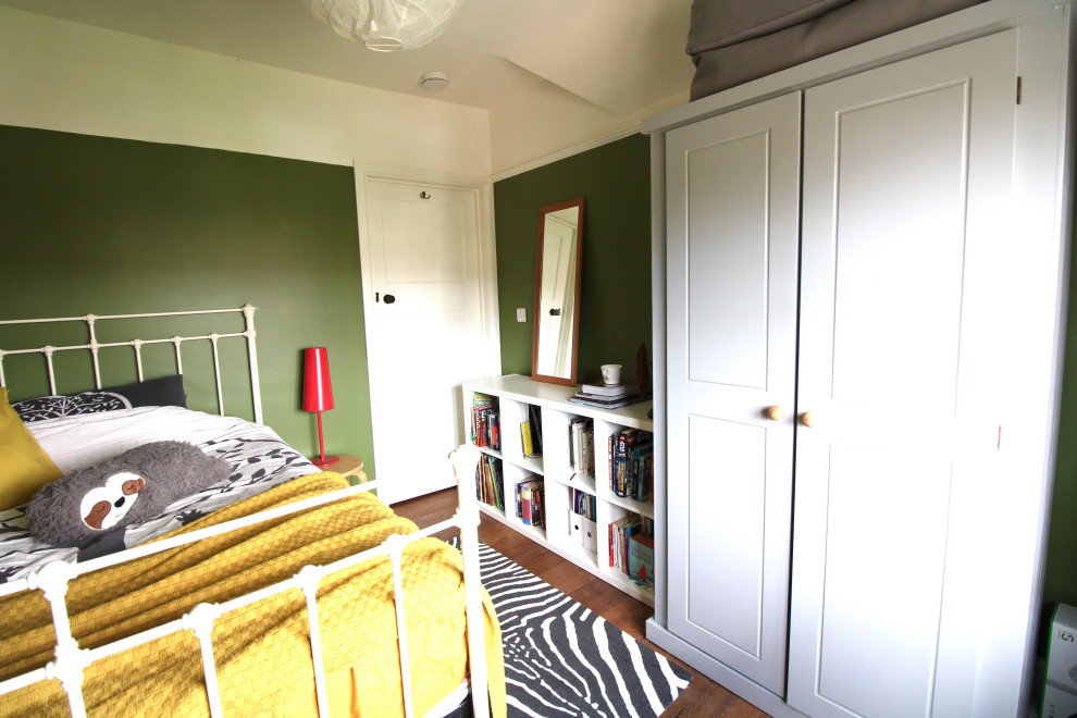 Design ideas for a mid-sized eclectic bedroom with green walls, dark hardwood floors and brown floor.