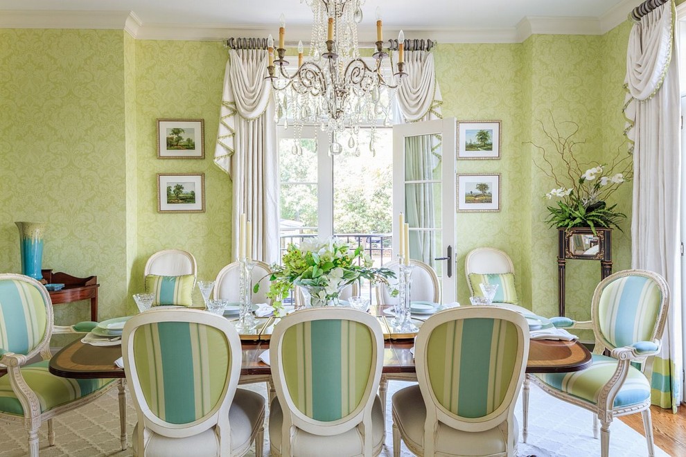 This is an example of a large traditional separate dining room in Raleigh with green walls and medium hardwood floors.