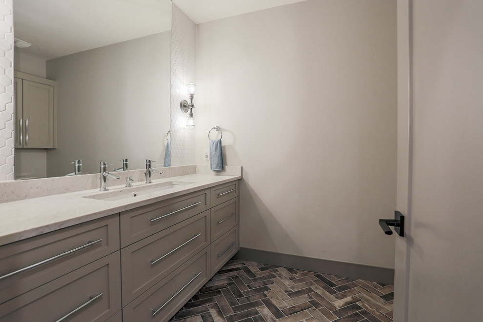 Inspiration for a modern 3/4 bathroom in Omaha with shaker cabinets, an alcove tub, an alcove shower, a two-piece toilet, white tile, porcelain tile, brick floors, an undermount sink, engineered quartz benchtops and a hinged shower door.