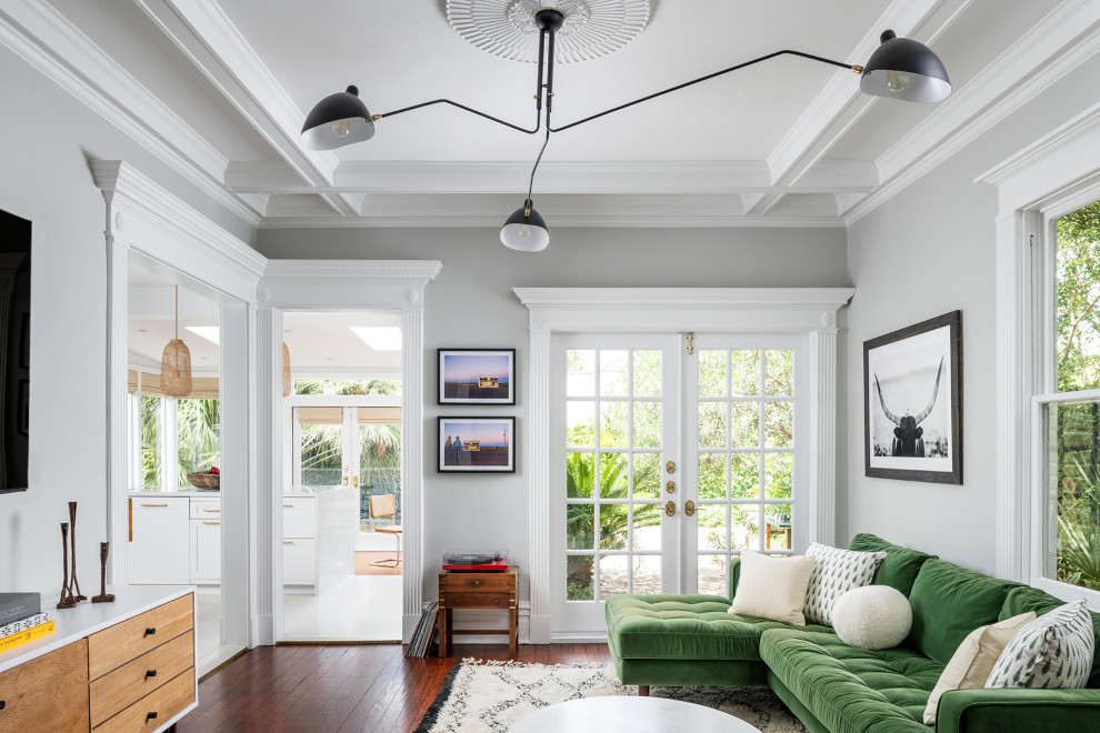 Example of a transitional enclosed dark wood floor and brown floor living room design with gray walls
