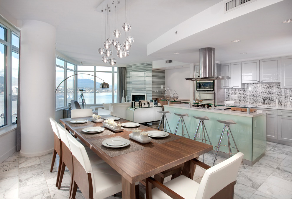 This is an example of a contemporary open plan dining in Vancouver with white walls.