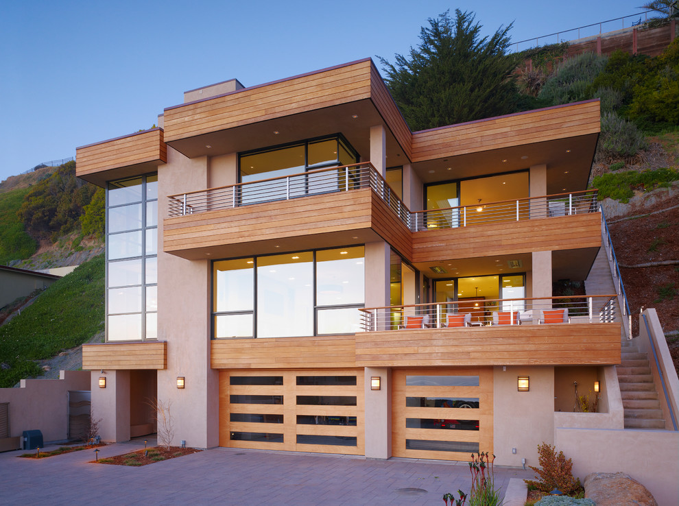 Photo of a mid-sized contemporary two-storey beige house exterior in San Francisco with wood siding and a flat roof.