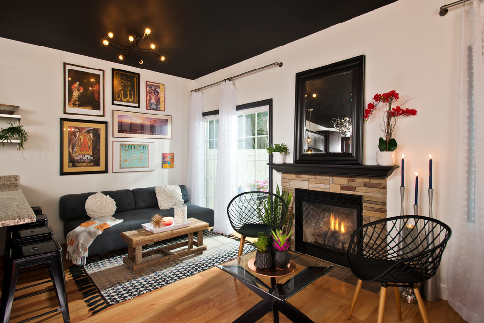 Living room - small contemporary open concept medium tone wood floor and brown floor living room idea in Other with white walls, a standard fireplace, a stone fireplace and no tv