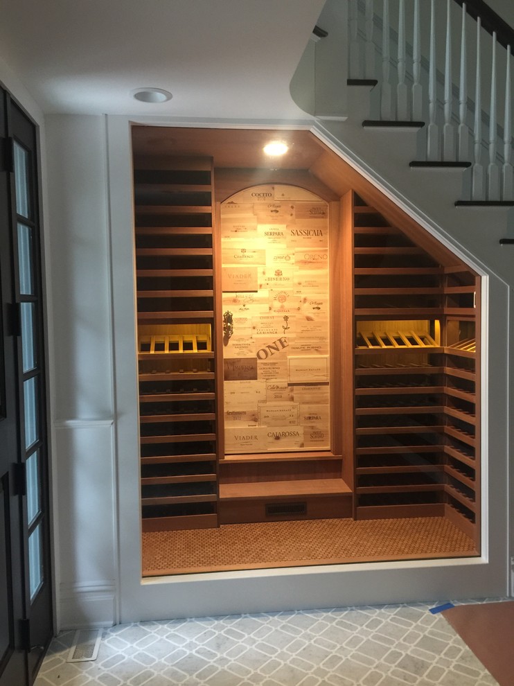 Design ideas for a small traditional wine cellar in New York with cork floors and brown floor.