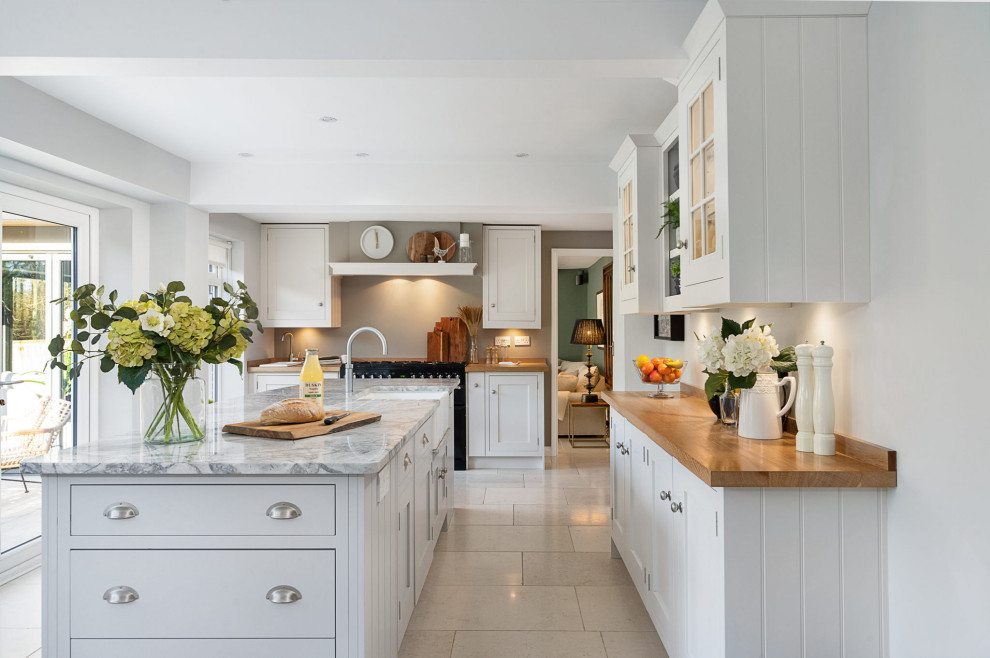 Mid-sized modern kitchen in Hampshire with an undermount sink, shaker cabinets, grey cabinets, marble benchtops, porcelain floors, with island, beige floor and beige benchtop.