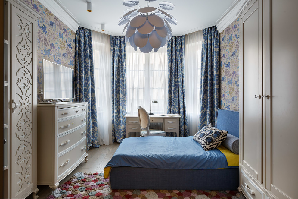 Photo of an eclectic kids' room for girls in London with light hardwood floors.