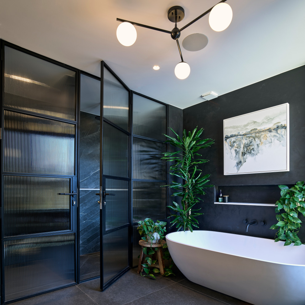 This is an example of a mid-sized contemporary master bathroom in London with a freestanding tub, a curbless shower, marble benchtops, an open shower, white benchtops, a double vanity and a floating vanity.