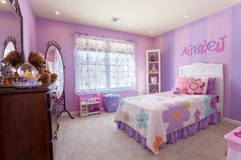 This is an example of a mid-sized traditional kids' bedroom for kids 4-10 years old and girls in Seattle with purple walls, carpet and beige floor.