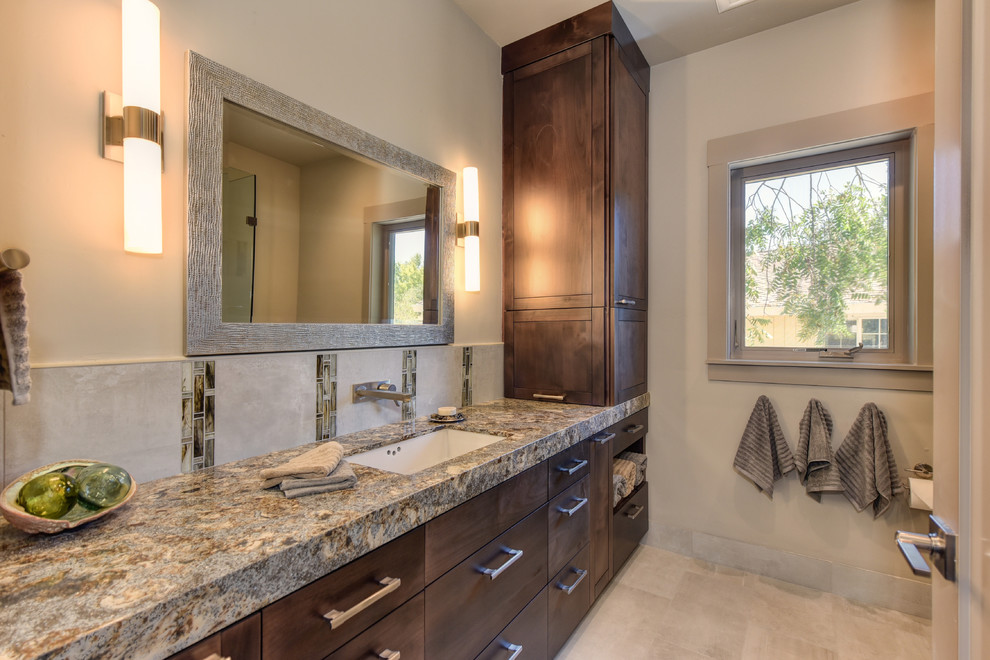 Photo of a mid-sized transitional bathroom in Sacramento with shaker cabinets, medium wood cabinets, a curbless shower, a one-piece toilet, gray tile, porcelain tile, porcelain floors, an undermount sink, engineered quartz benchtops, grey floor, a hinged shower door and multi-coloured benchtops.