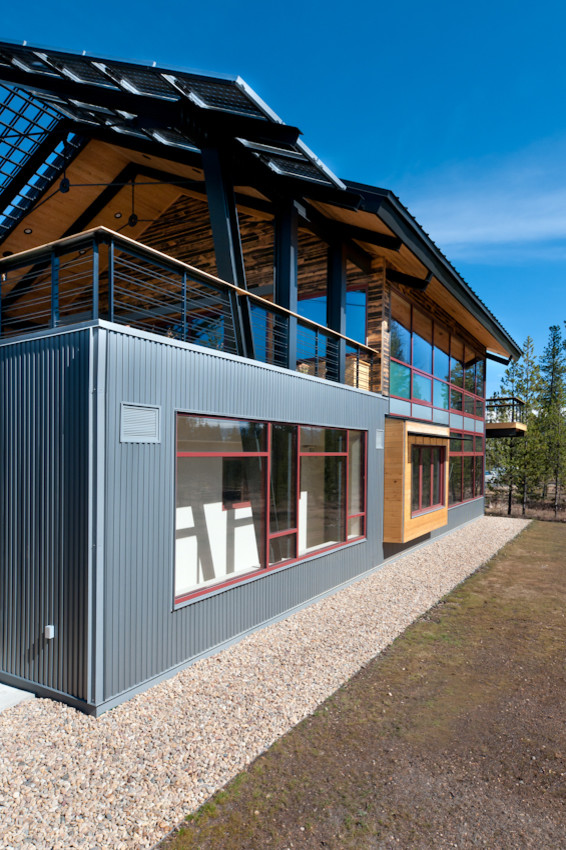 Contemporary two-storey multi-coloured house exterior in Denver with metal siding, a gable roof and a mixed roof.