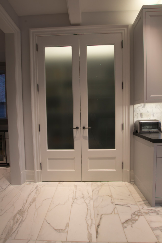 Example of a large transitional l-shaped marble floor, gray floor and coffered ceiling kitchen pantry design in Toronto with an integrated sink, flat-panel cabinets, stainless steel cabinets, quartz countertops, white backsplash, marble backsplash, stainless steel appliances, two islands and gray countertops