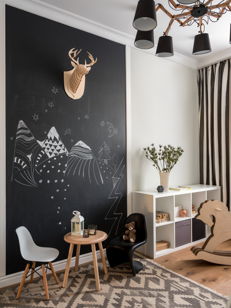 Design ideas for a transitional gender-neutral kids' room in Moscow with black walls, medium hardwood floors and brown floor.