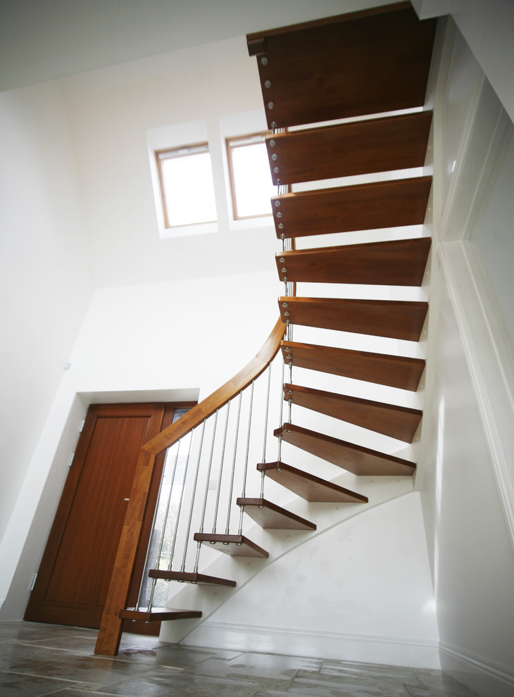 Mid-sized contemporary wood l-shaped staircase in Hampshire with open risers.