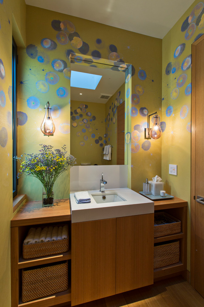 This is an example of a contemporary powder room in San Francisco with an undermount sink, flat-panel cabinets, medium wood cabinets and multi-coloured walls.
