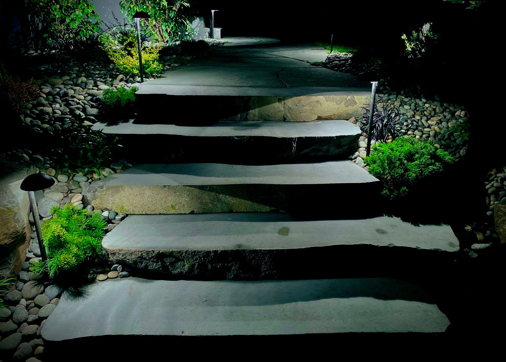 Photo of a rustic partial sun river rock landscaping in Vancouver.
