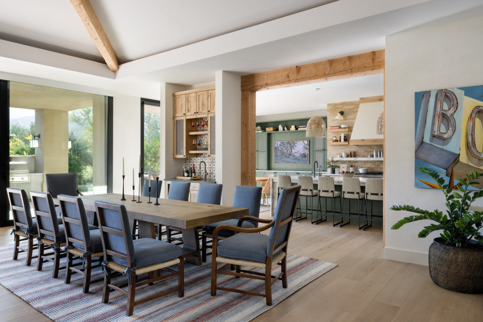 Example of a huge southwest light wood floor, beige floor and exposed beam great room design with beige walls