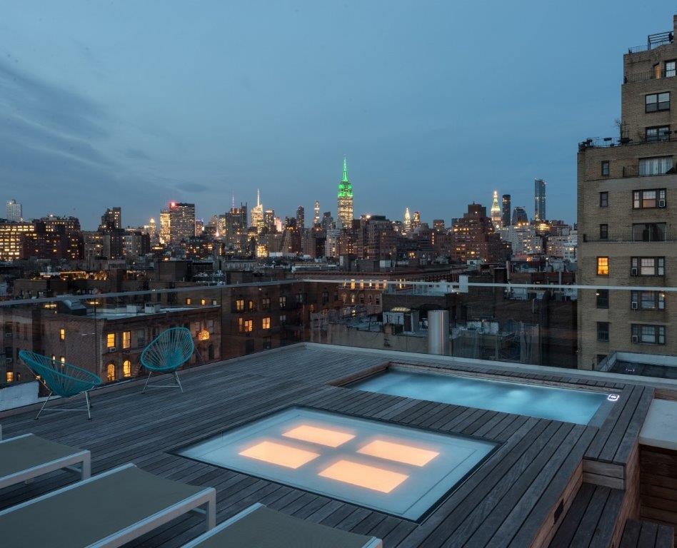 Inspiration for a small contemporary rooftop rectangular lap pool in New York with decking.