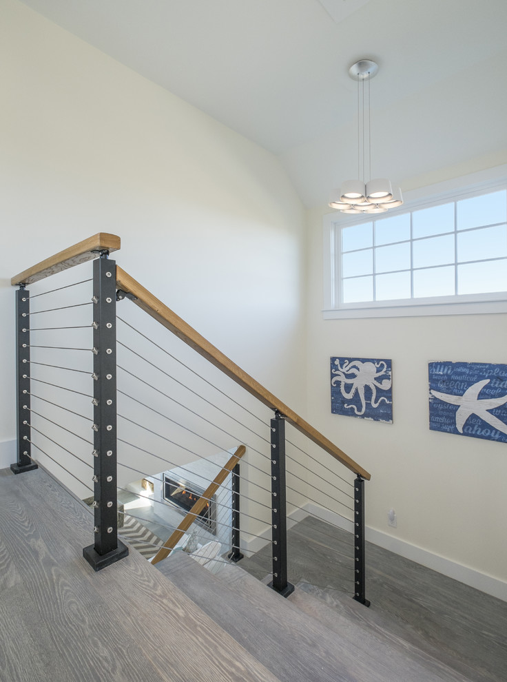 This is an example of a mid-sized beach style wood l-shaped staircase in Boston with wood risers.