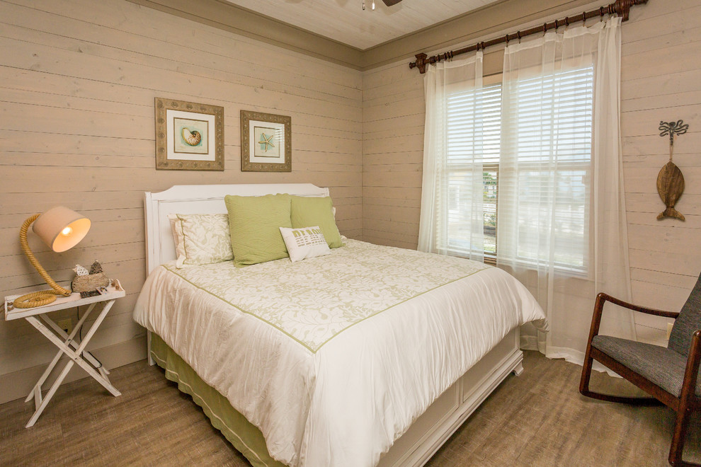 Photo of a beach style guest bedroom in Miami with brown walls and vinyl floors.