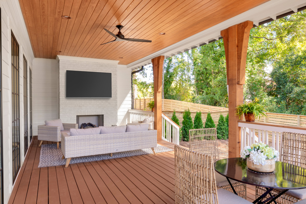 Inspiration for a large beach style backyard verandah in Charlotte with with fireplace and a roof extension.