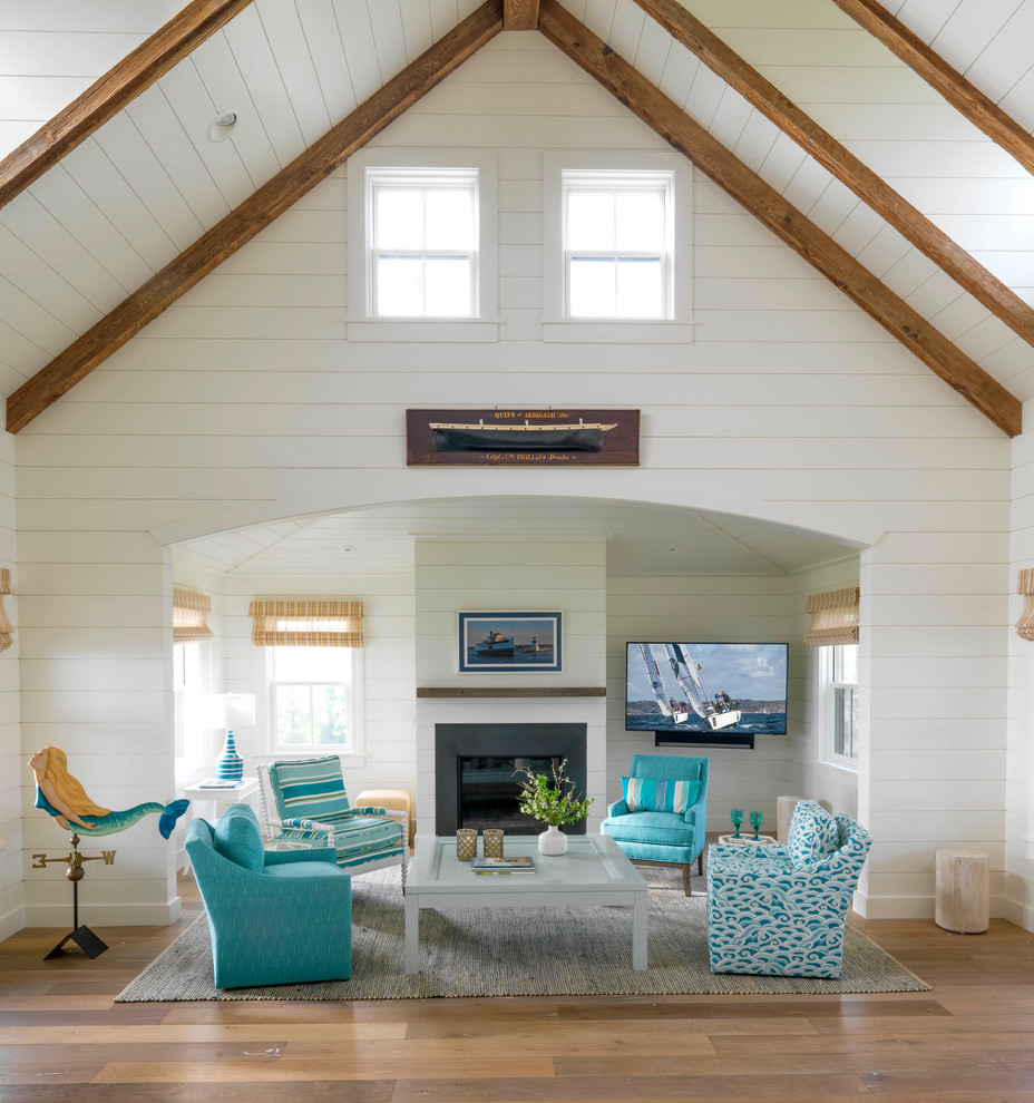 Design ideas for a large beach style open concept living room in Boston with white walls, medium hardwood floors, a standard fireplace, a wall-mounted tv, brown floor, a metal fireplace surround, vaulted and wood walls.
