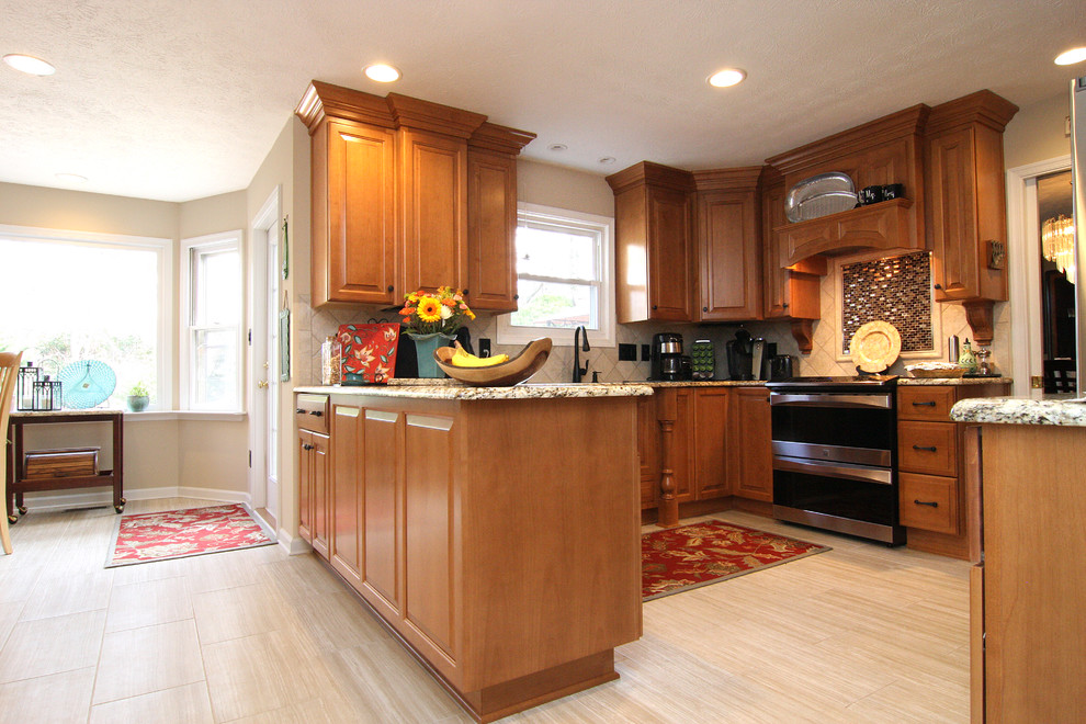 Large transitional u-shaped porcelain tile eat-in kitchen photo with raised-panel cabinets, medium tone wood cabinets, granite countertops, beige backsplash, porcelain backsplash, stainless steel appliances and an undermount sink