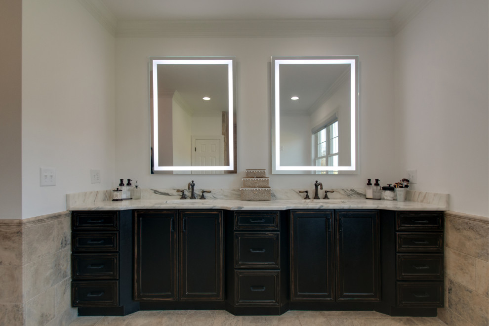 Mid-sized country master bathroom in Nashville with recessed-panel cabinets, black cabinets, a freestanding tub, an open shower, a one-piece toilet, white tile, ceramic tile, white walls, limestone floors, an undermount sink, marble benchtops, brown floor, an open shower, white benchtops, a double vanity and a built-in vanity.